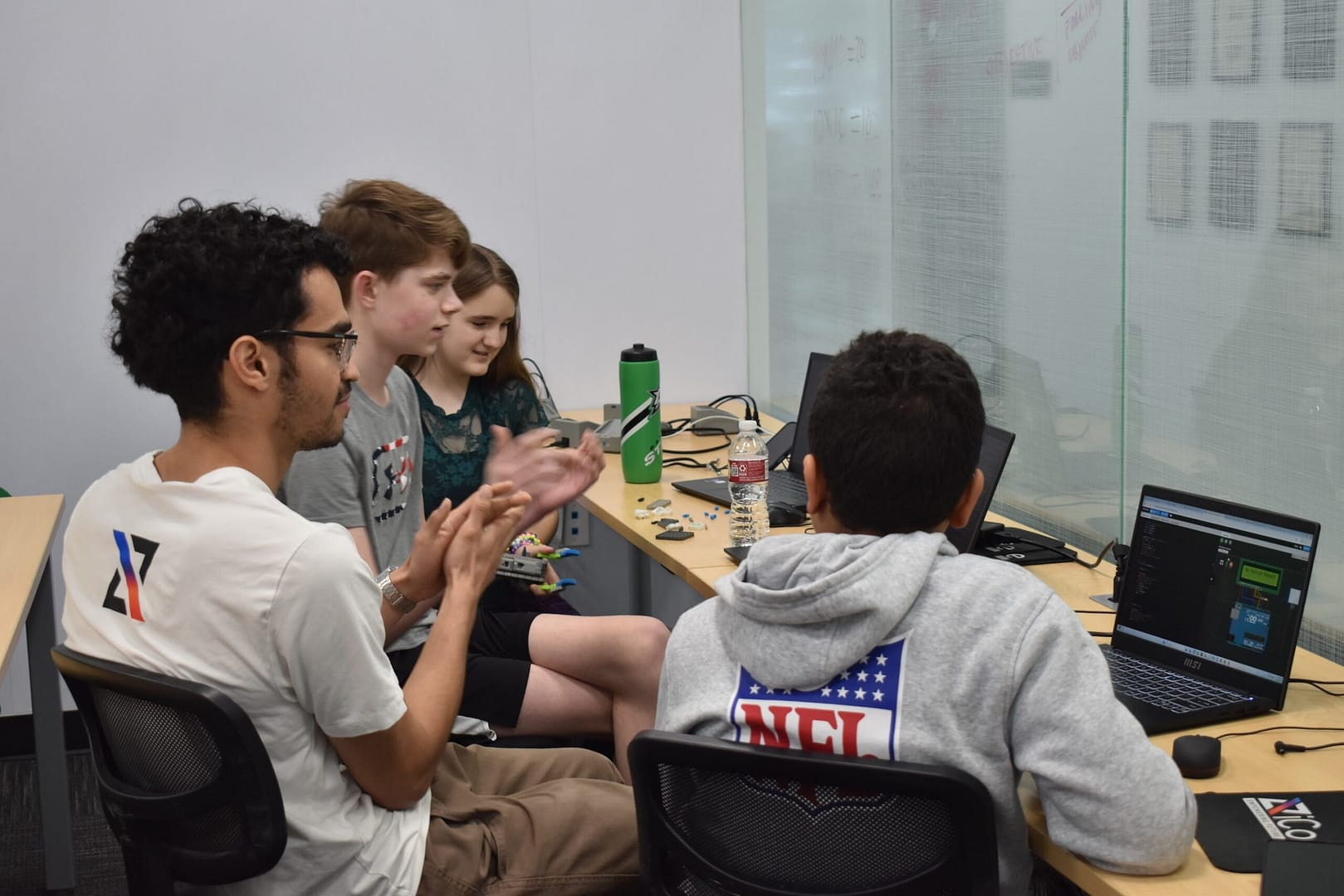 An iCode instructor works with students learning about robotics